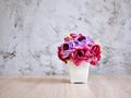 Purple colored artificial rose flowers bouquet in pot on table Royalty Free Stock Photo