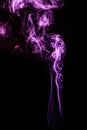 Purple colored puffed smoke in a dark background