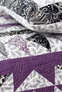 Purple coloured handmade patchwork bed quilt and pillow with various fabric geometric patterns