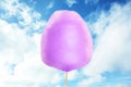 Purple cotton candy against sky with clouds