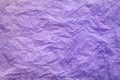 Purple crumpled paper background with a pronounced texture.