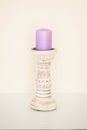 Purple decorative candle stands in a high candlestick