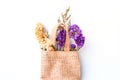 Purple dried flowers in brown sack bags