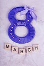 Purple eight and text March