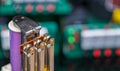 Power electromechanical relay and blurry electronic components on colored background with bokeh