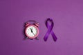 Purple epilepsy awareness ribbon with alarm clock on a purple background. World epilepsy day