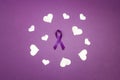 Purple epilepsy awareness ribbon wit white heats on a purple background. World epilepsy day