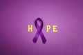 Purple epilepsy awareness ribbon with word hopr on a purple background. World epilepsy day Royalty Free Stock Photo