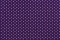 Purple fabric and white tiny polka dots background. Royalty Free Stock Photo