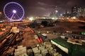 Purple Ferris wheel and construction in Hong Kong by night