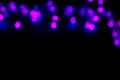 Purple Festive Christmas abstract bokeh lights on dark background with copy space for text or design