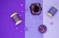 Purple flat lay: against the background of three shades of purple are a dark, almost black rose flower, lilac beads, wooden reels