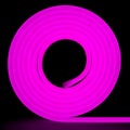 Purple flexible glowing led tape neon in reel standing on black background Royalty Free Stock Photo