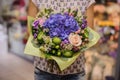 Purple flower bouquet composition in hands Royalty Free Stock Photo