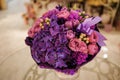 Purple flower bouquet composition on table Royalty Free Stock Photo