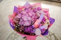 Purple flower bouquet composition on table Royalty Free Stock Photo
