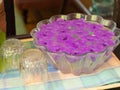 Purple flowers floating on glass jar. Royalty Free Stock Photo