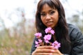 Purple flowers in the hands of an African woman, portrait Royalty Free Stock Photo