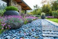 Purple flowers and rocks adorn the garden in front of a house