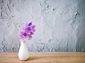 Purple flowers in vase on the table,Purple-pink flower still life on texture background or wallpaper Common water hyacinth Eichhor Royalty Free Stock Photo