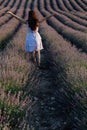 a woman standing with her back in a field of lavender walk nature