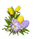 Purple freesia flowers and yellow tulips in a Easter corner floral arrangement with painted eggs isolated on white Royalty Free Stock Photo