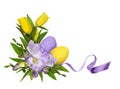 Purple freesia flowers and yellow tulips in a Easter corner floral arrangement with painted eggs isolated on white Royalty Free Stock Photo