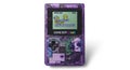 Purple Game Boy Color displaying The Legend of Zelda Link\'s Awakening title screen with green and yellow text on LCD display Royalty Free Stock Photo