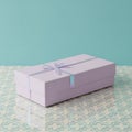 Purple Gift Box with Bow on Patterned Surface Royalty Free Stock Photo
