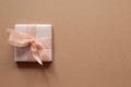 Purple gift box isolated on brown background Royalty Free Stock Photo