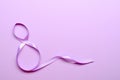 Purple gift celebration ribbon in 8 namber over purple background. 8 march concept. Royalty Free Stock Photo