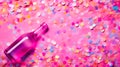 purple glass bottle lying on a vibrant pink background with multicolored confetti, suggesting a joyful and festive