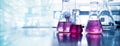 Purple glass flask in blue research chemistry science banner laboratory background Royalty Free Stock Photo