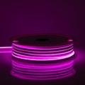 Purple glowing LED neon flex strip on black dark background Royalty Free Stock Photo