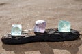 Purple and Green Fluorite Natural Octahedron Crystals on the beach