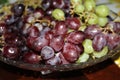 Purple and green grapes on a plate