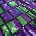Purple and Green Rectangular Sequins on Black Fabric Close Up texture Royalty Free Stock Photo