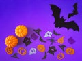 Purple Halloween background with decorative ghosts, pumpkins, spiders, bats. Happy Halloween