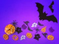 Purple Halloween background with decorative ghosts, pumpkins, spiders, bats. Happy Halloween