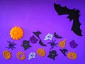 Purple Halloween background with decorative ghosts, pumpkins, spiders, bats. Happy Halloween