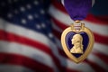 Purple Heart Miltary Merit Medal Against Darkened American Flag Royalty Free Stock Photo