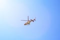 Purple helicopter tour flies against background of clear blue sky. Photo of a flying vehicle with blurred rotating blades Royalty Free Stock Photo