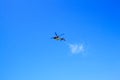 Purple helicopter tour flies against background of clear blue sky. Photo of a flying vehicle with blurred rotating blades Royalty Free Stock Photo