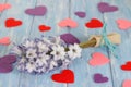 Purple hyacinth flower and hearts on shabby blue wooden planks in rustic style.