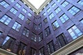 Purple inner corner of building. House with large panoramic windows. Architectural detail Modern corner of building facade, sky Royalty Free Stock Photo