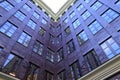 Purple inner corner of building. House with large panoramic windows. Architectural detail Modern corner of building facade, sky Royalty Free Stock Photo