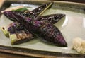 Purple Japanese BBQ eggplants are placed in a porcelain dish Royalty Free Stock Photo