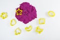 Purple kinetic sand, plastic molds for sand. Top view. White background