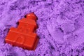 Purple kinetic sand with shapes