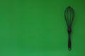 Purple Kitchen whisk icon isolated on green background.